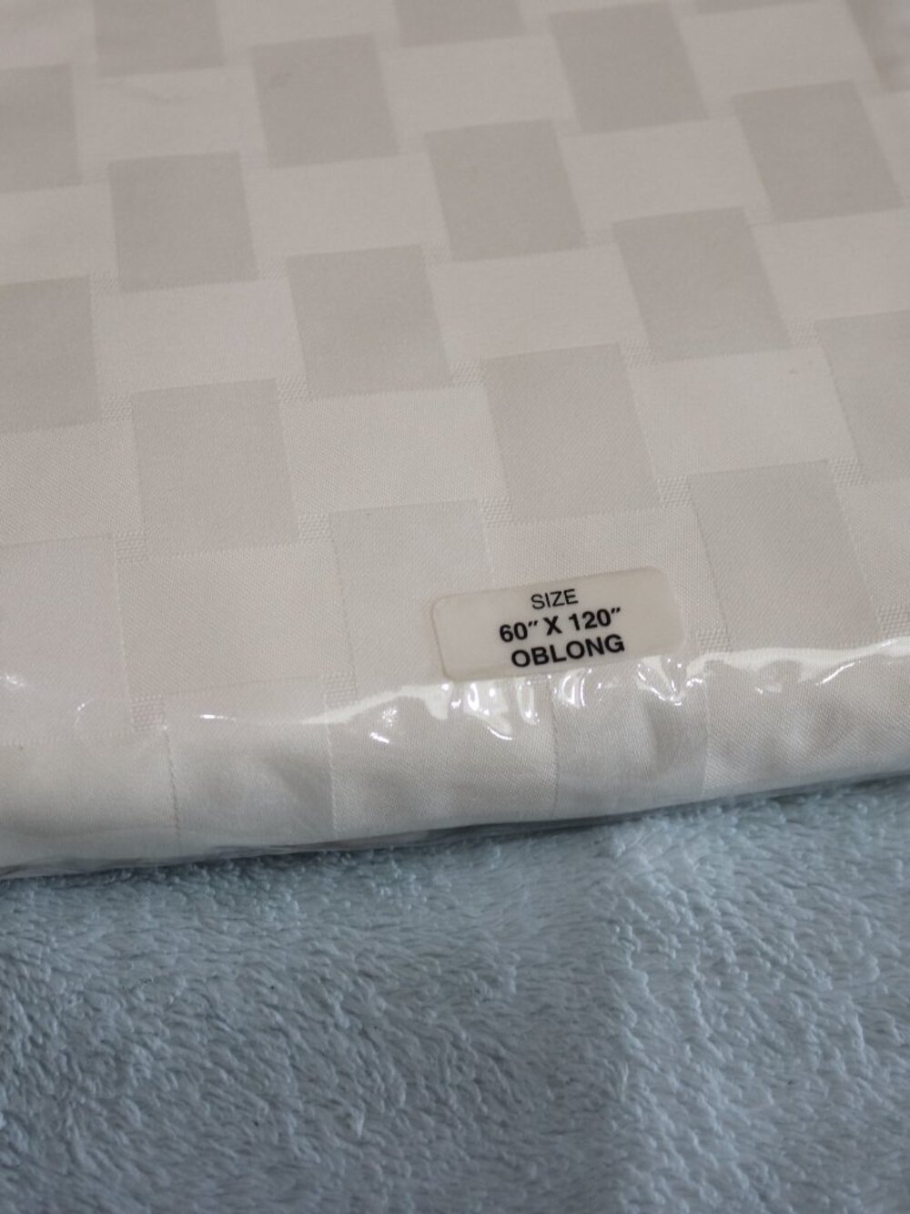 Reflections Microfiber cream checkered tablecloth. New. 60x120.